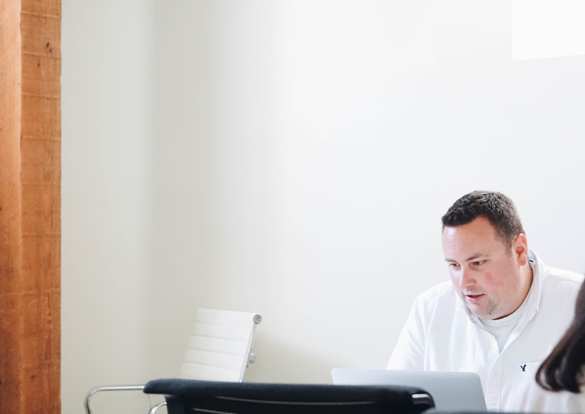 A man working at a laptop in the Orium office.