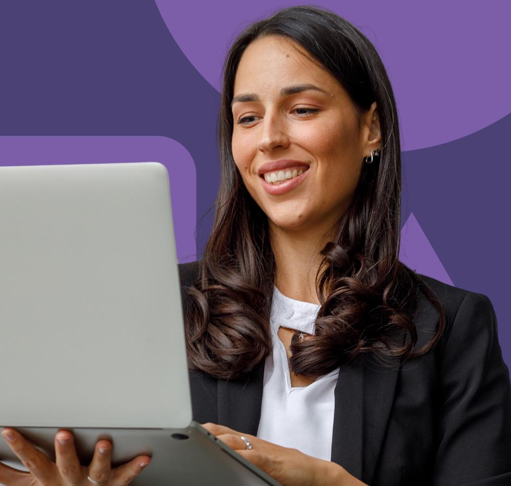 A smiling professional reviewing observability dashboards on a laptop