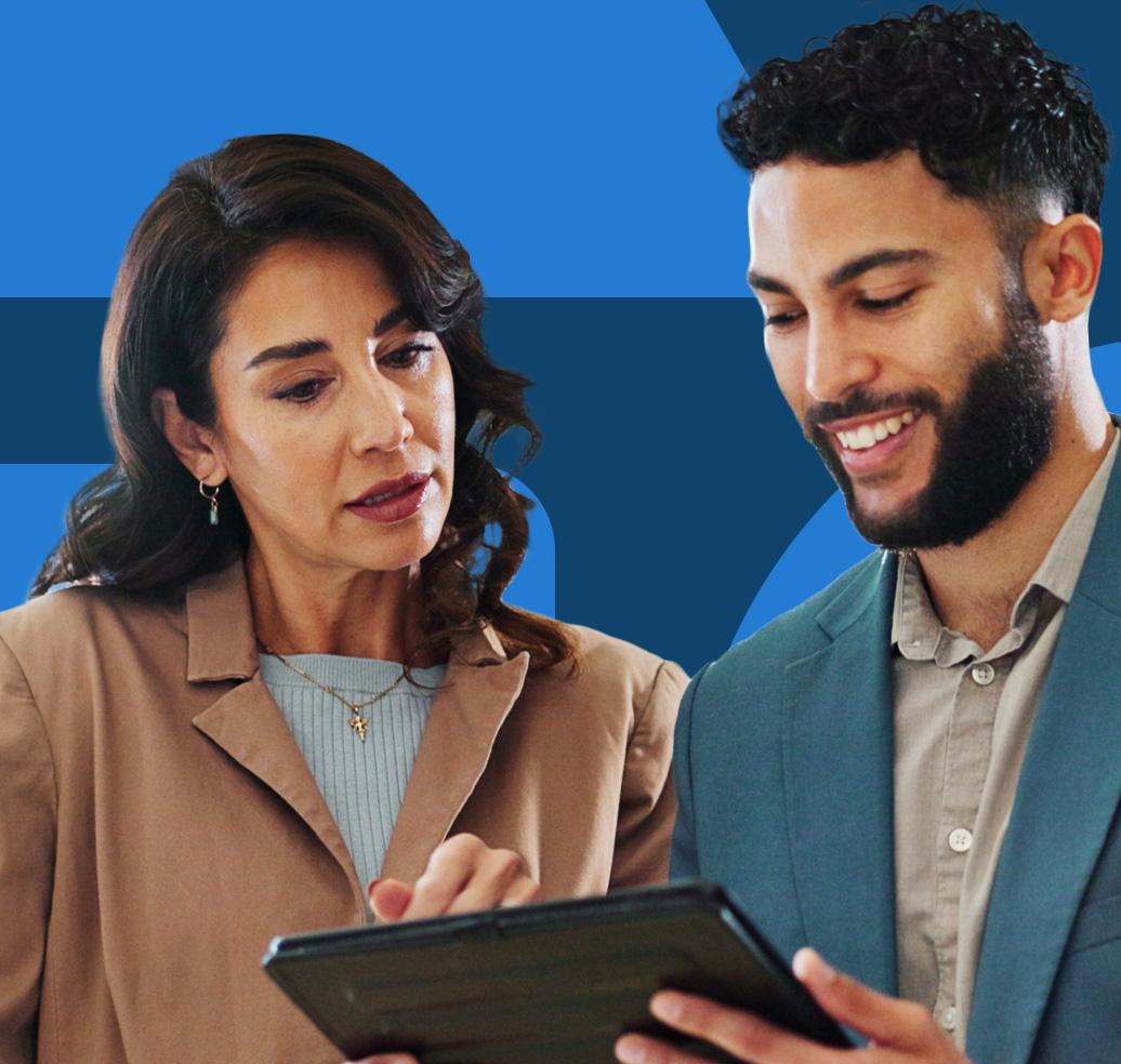 Two executives reviewing content on a tablet during a briefing