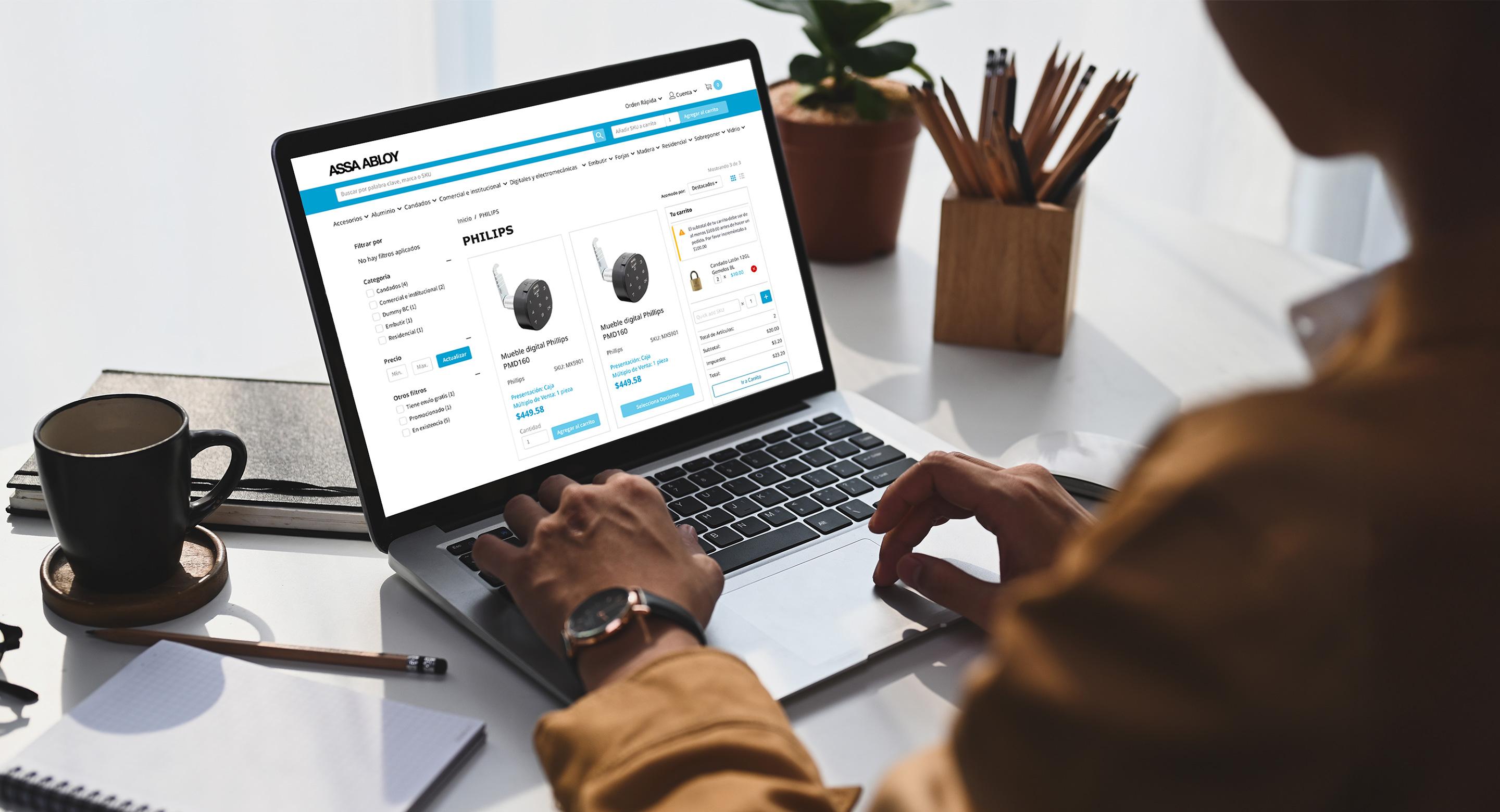 A woman uses the ASSA ABLOY website to purchase a new digital door lock device.