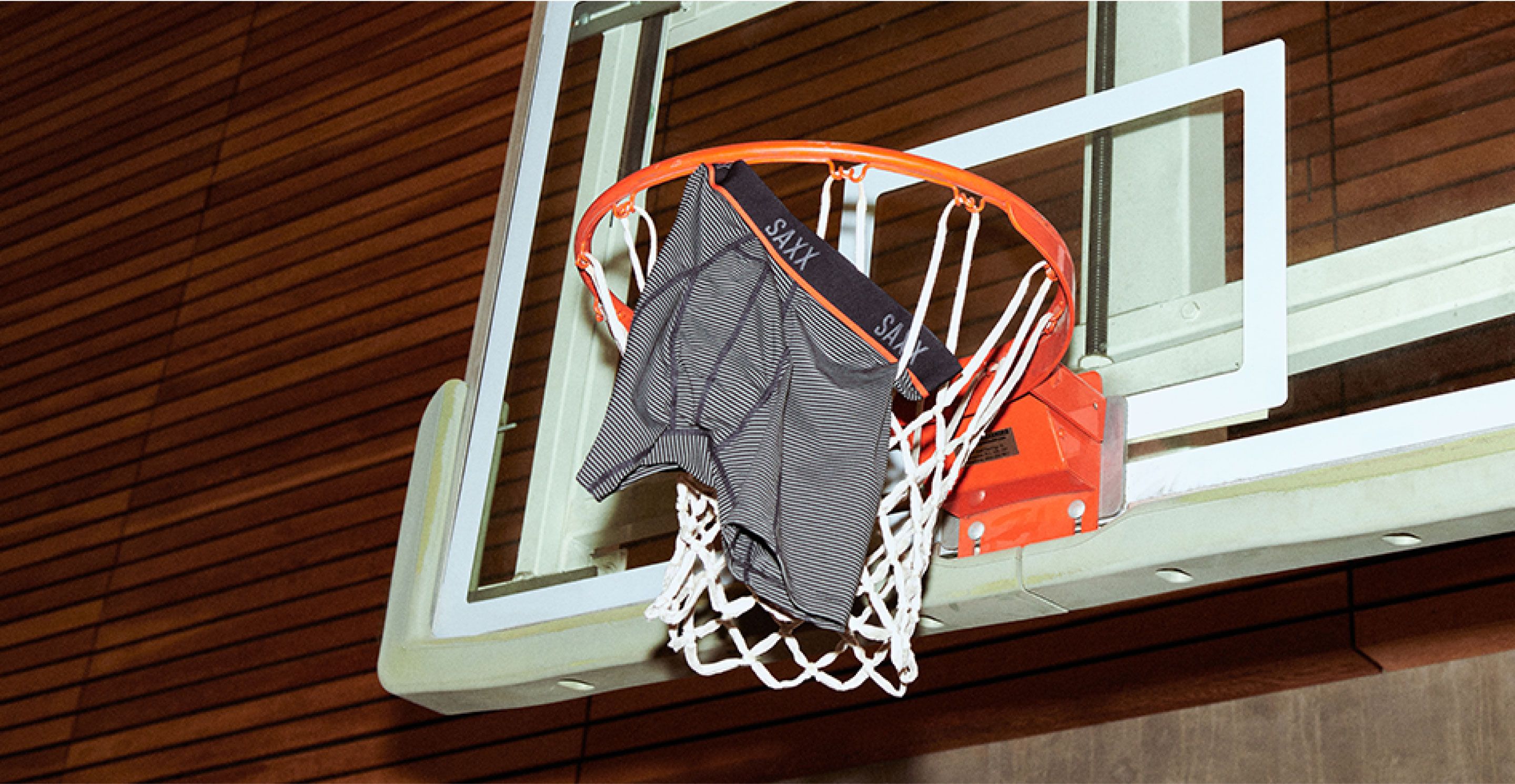 A pair of SAXX underwear hangs from a basketball net.