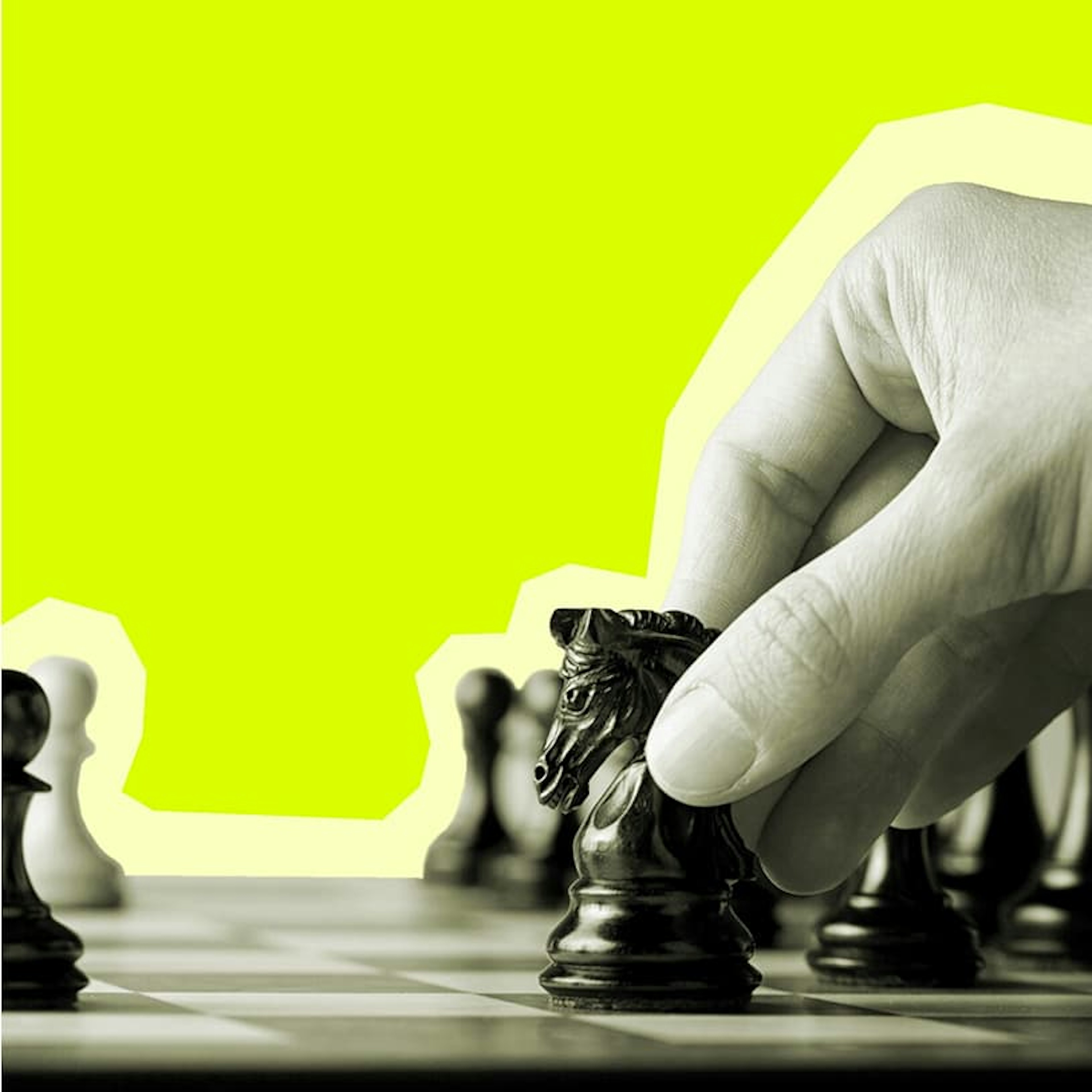 A close-up of a hand moving the black knight chess piece on a chess board to represent strategic advancement.