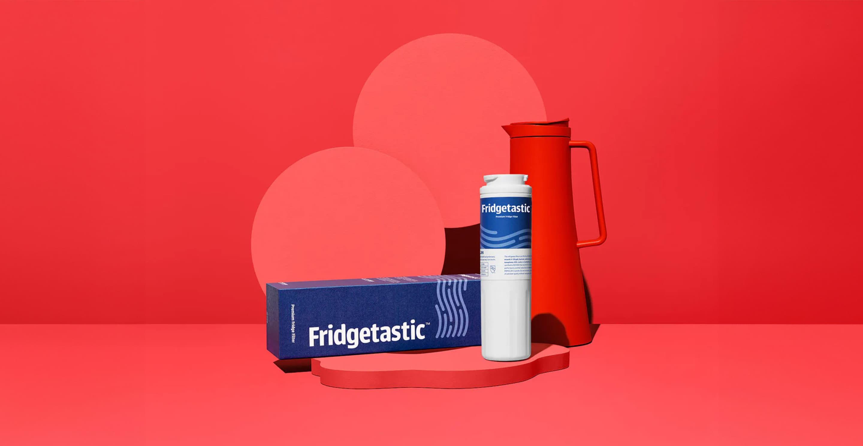 FilterEasy’s Fridgetastic box and filter are shown on a short pedestal with a red water bottle behind them.