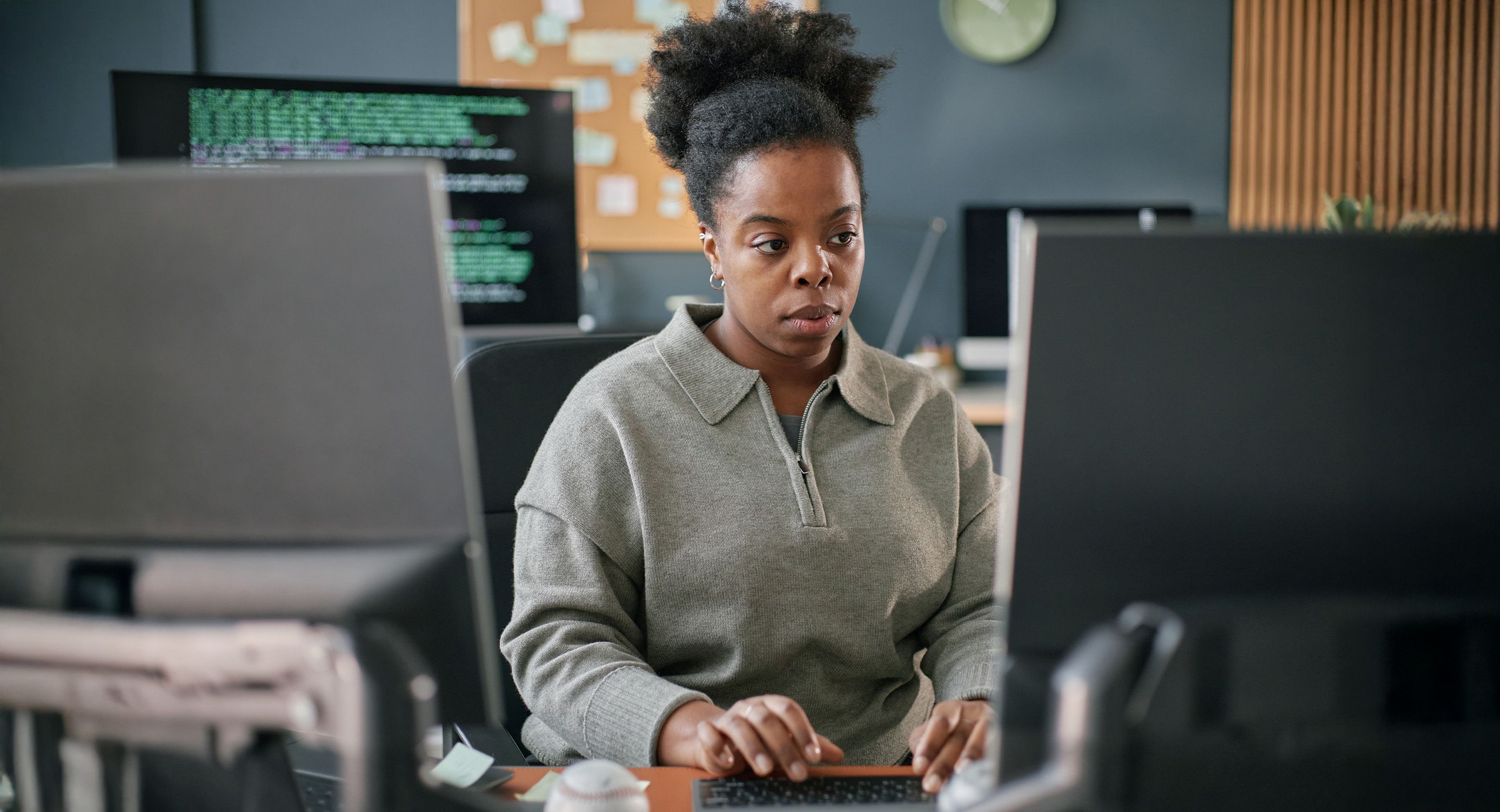 Developer working at desktop computer in modern office environment
