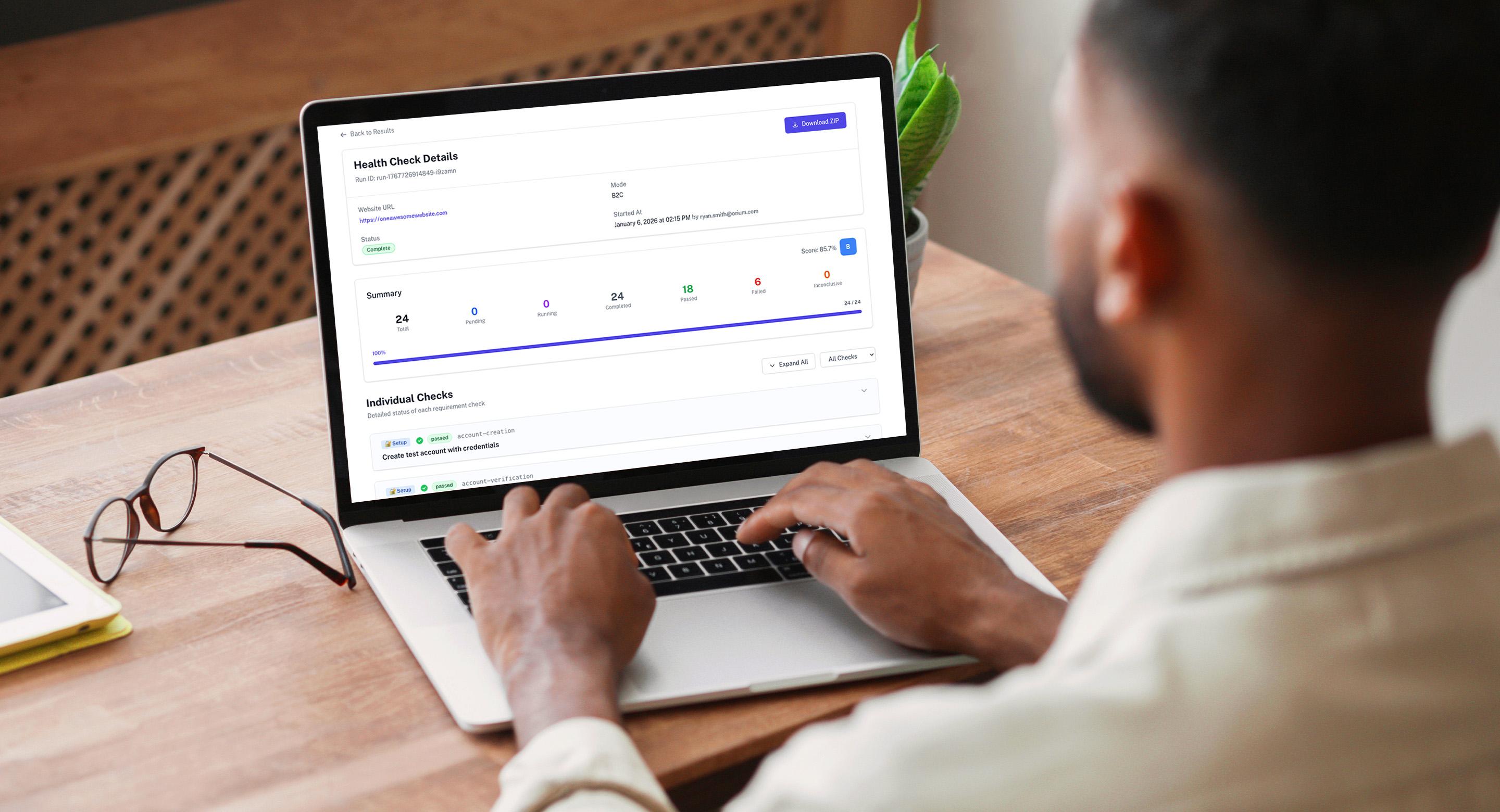 Person working on a laptop displaying a website health check summary dashboard.