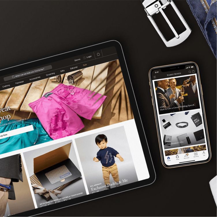 Tablet and smartphone displaying ecommerce websites on a desk.