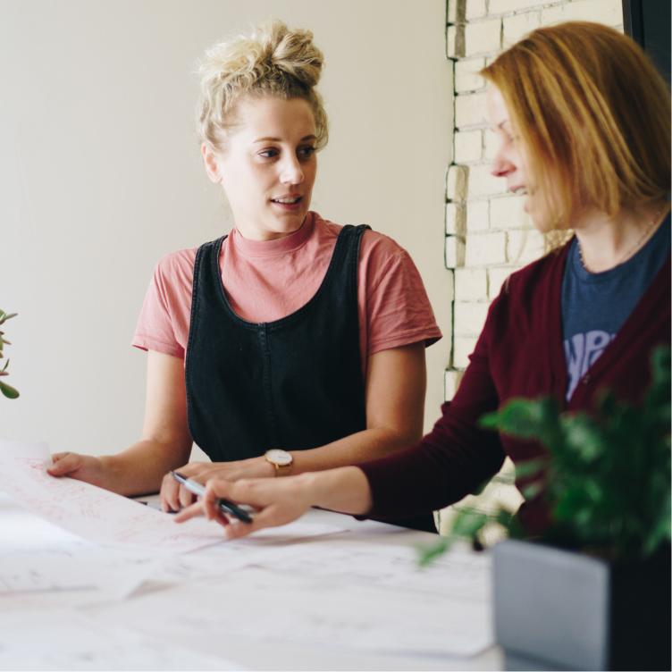 Two people reviewing documents together at a table.