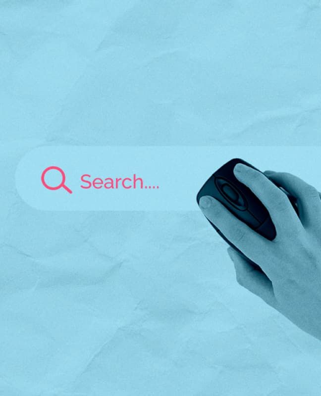 A hand on a computer mouse imposed overtop a website Search bar.