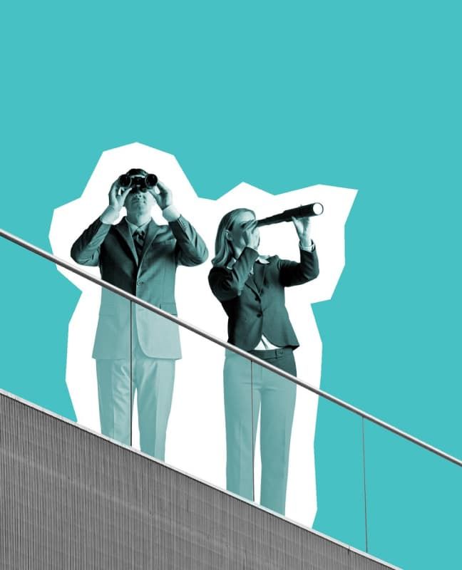 Two people on a rooftop. One is looking out with a telescope and one is looking out with binoculars.