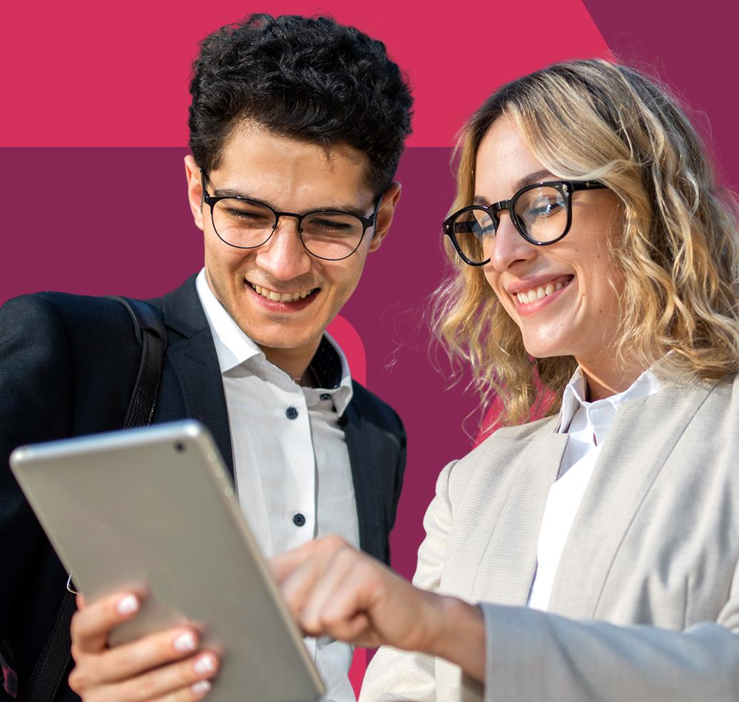 A young man in a white t-shirt smiles while looking at his smartphone, against a magenta background.