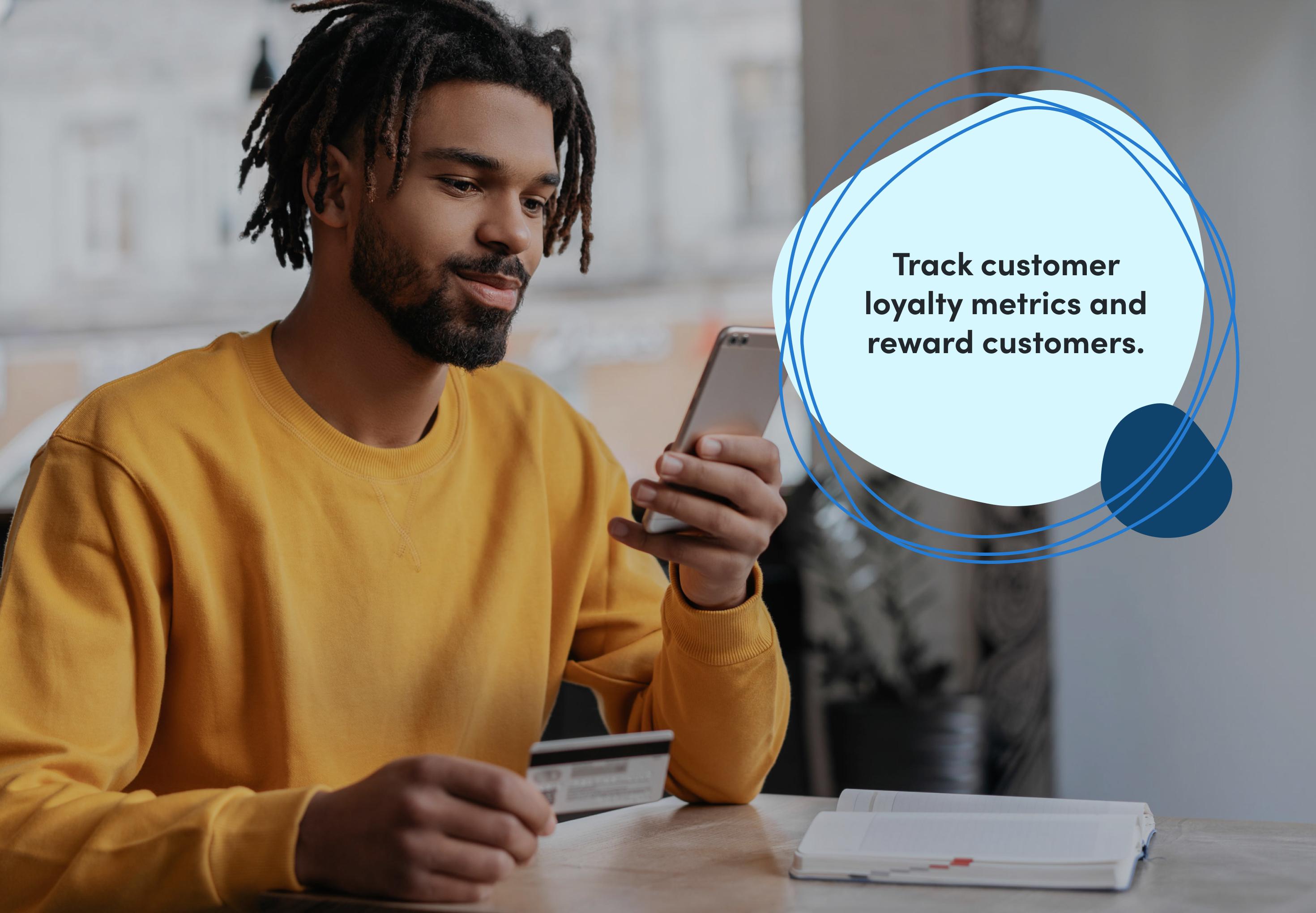 A man uses a mobile phone to pay for something with a text bubble overlaid reading “Track customer loyalty metrics and reward customers.“