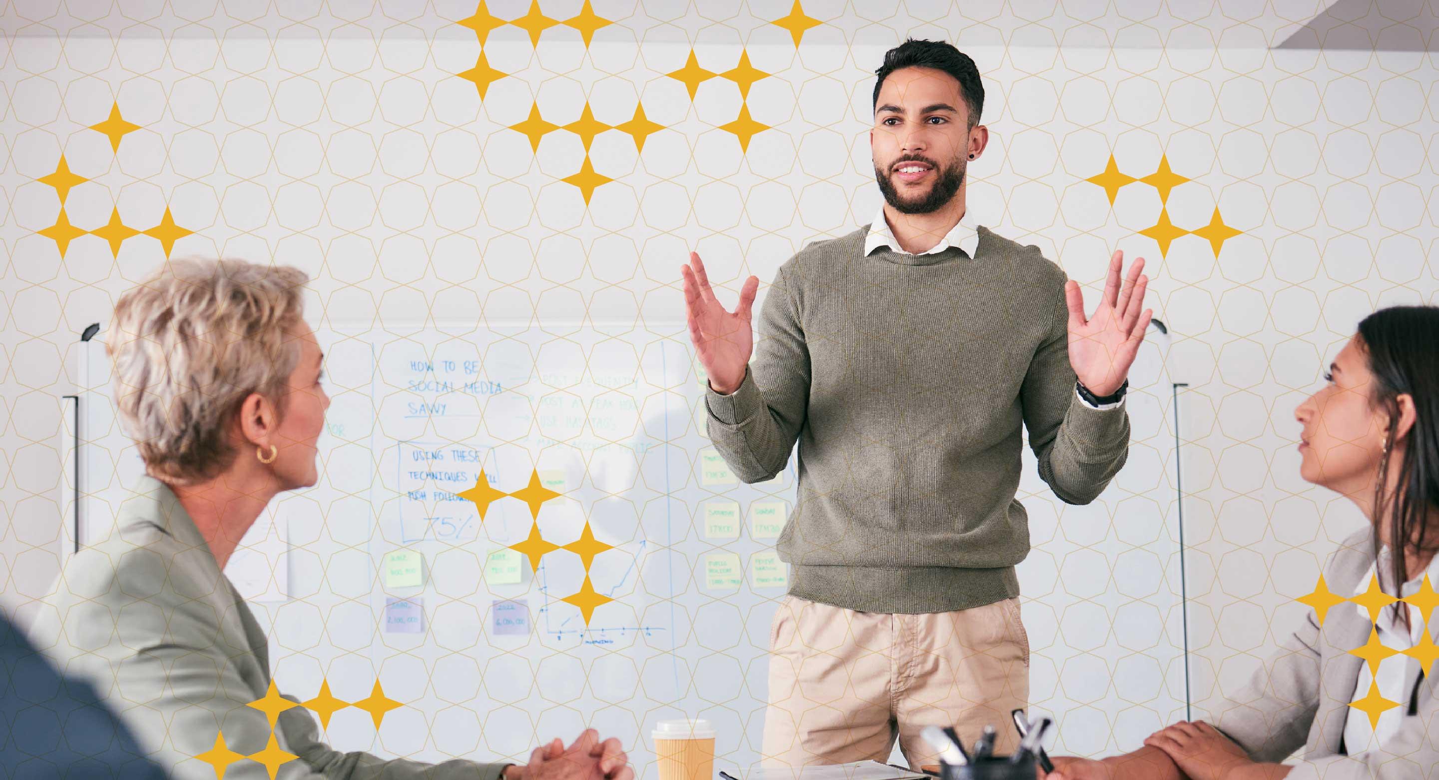 A man stands at the front of a room presenting to colleagues.