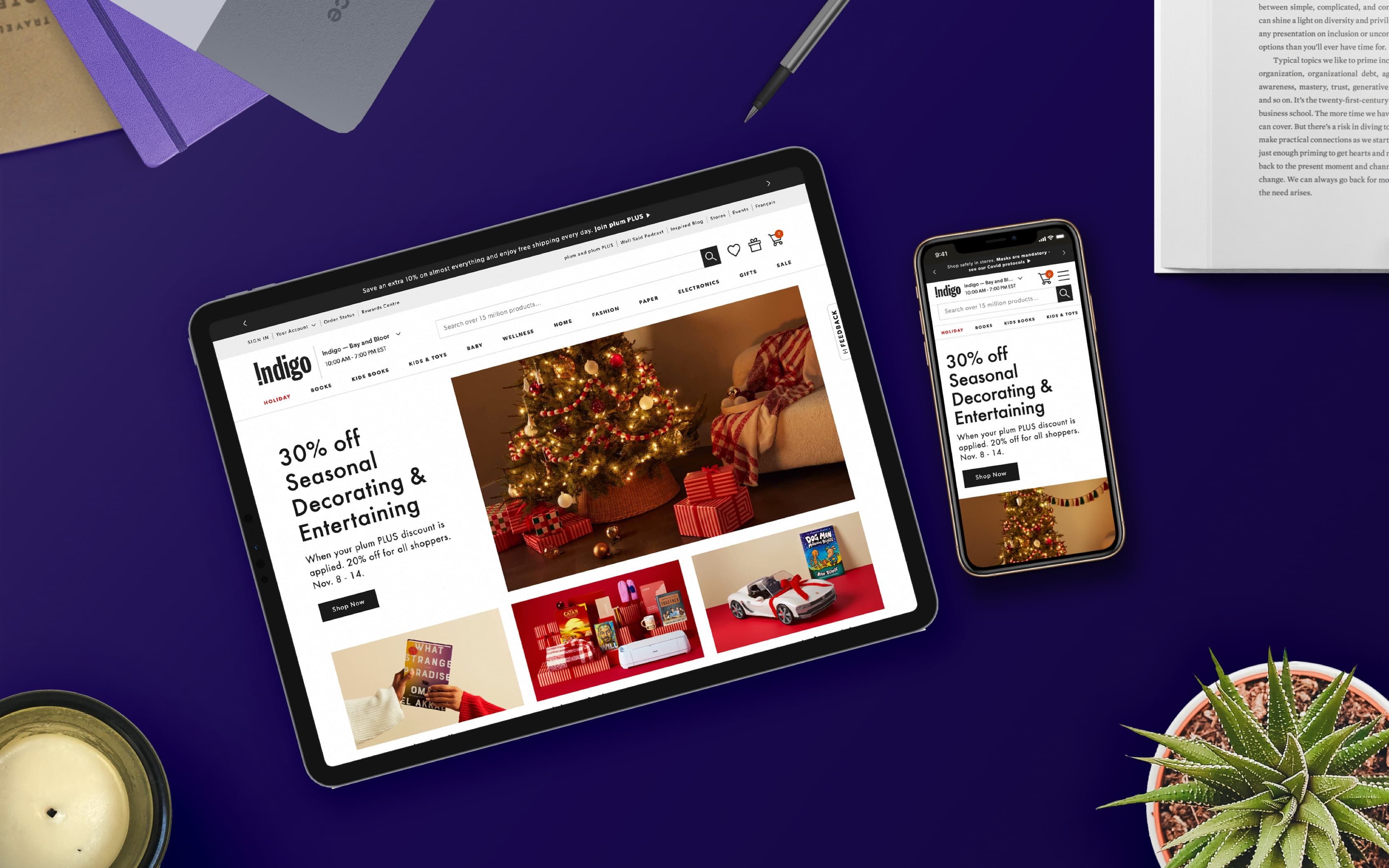 Flatlay of Indigo website on an iPad and iPhone with books, stationary, and plants around the devices.