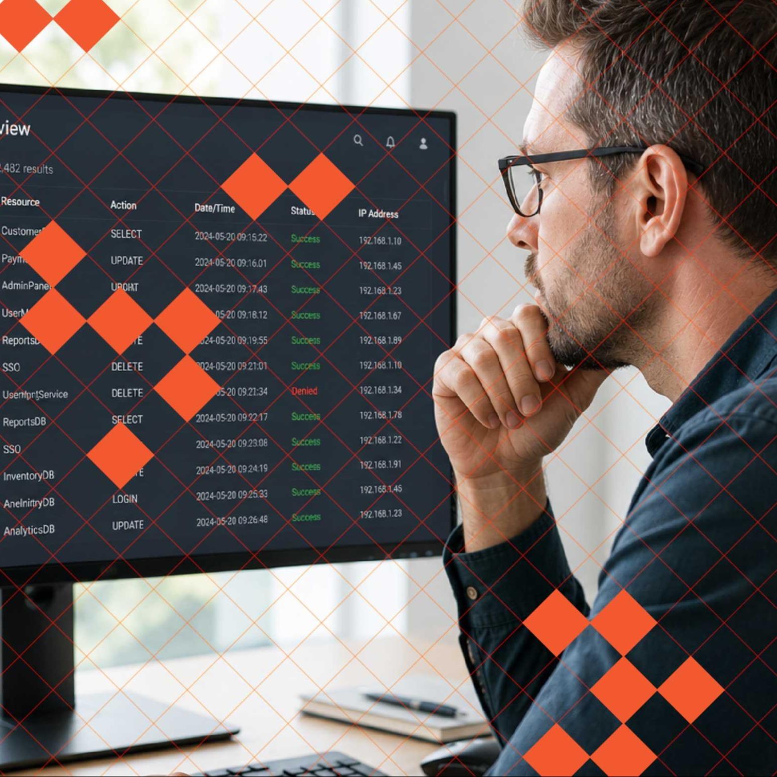 A man sits in front of a computer reviewing a dashboard.