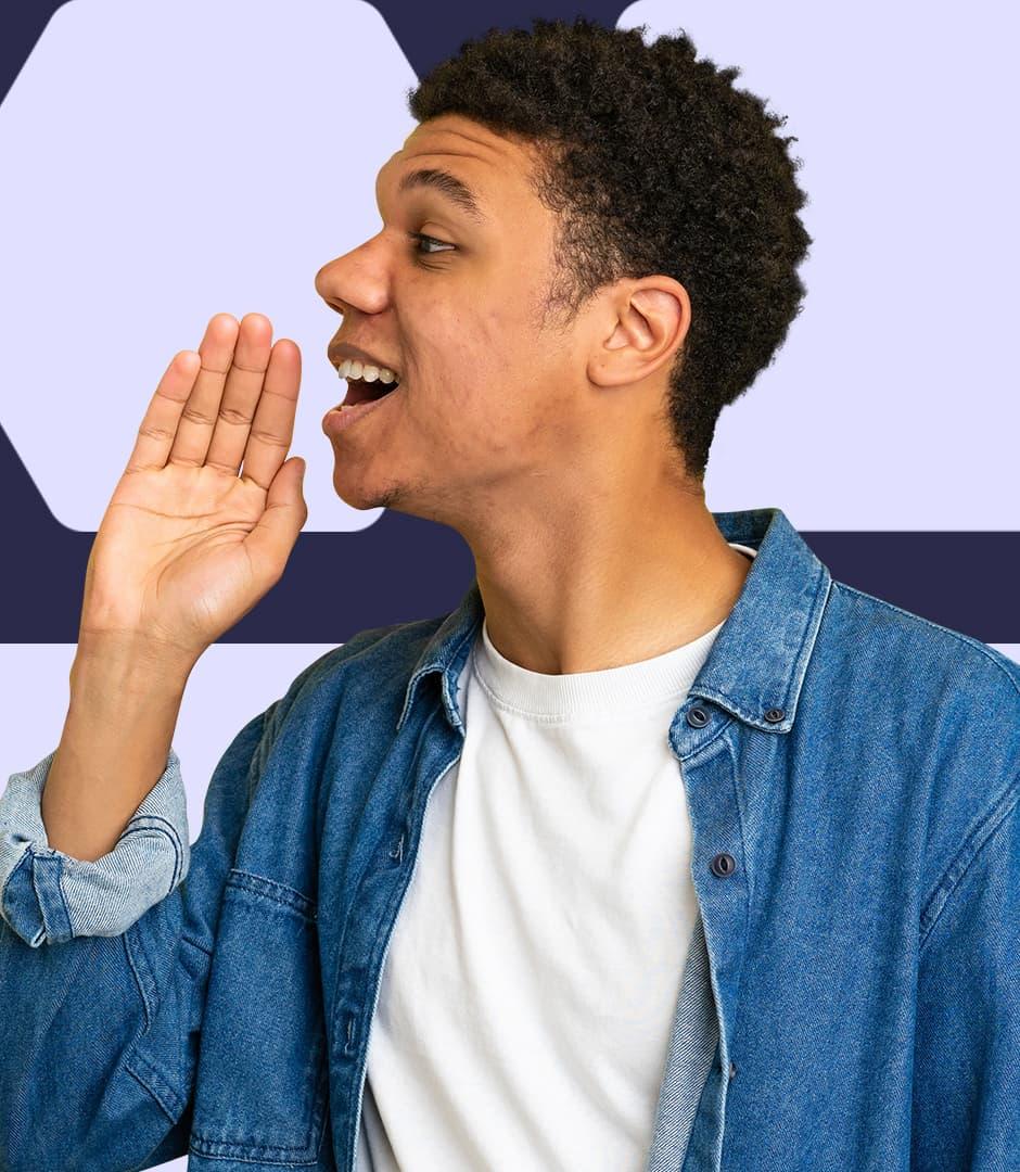 A man wearing a denim button-down shirt and white t-shirt underneath is facing the side, with a hand near their mouth to amplify their voice.