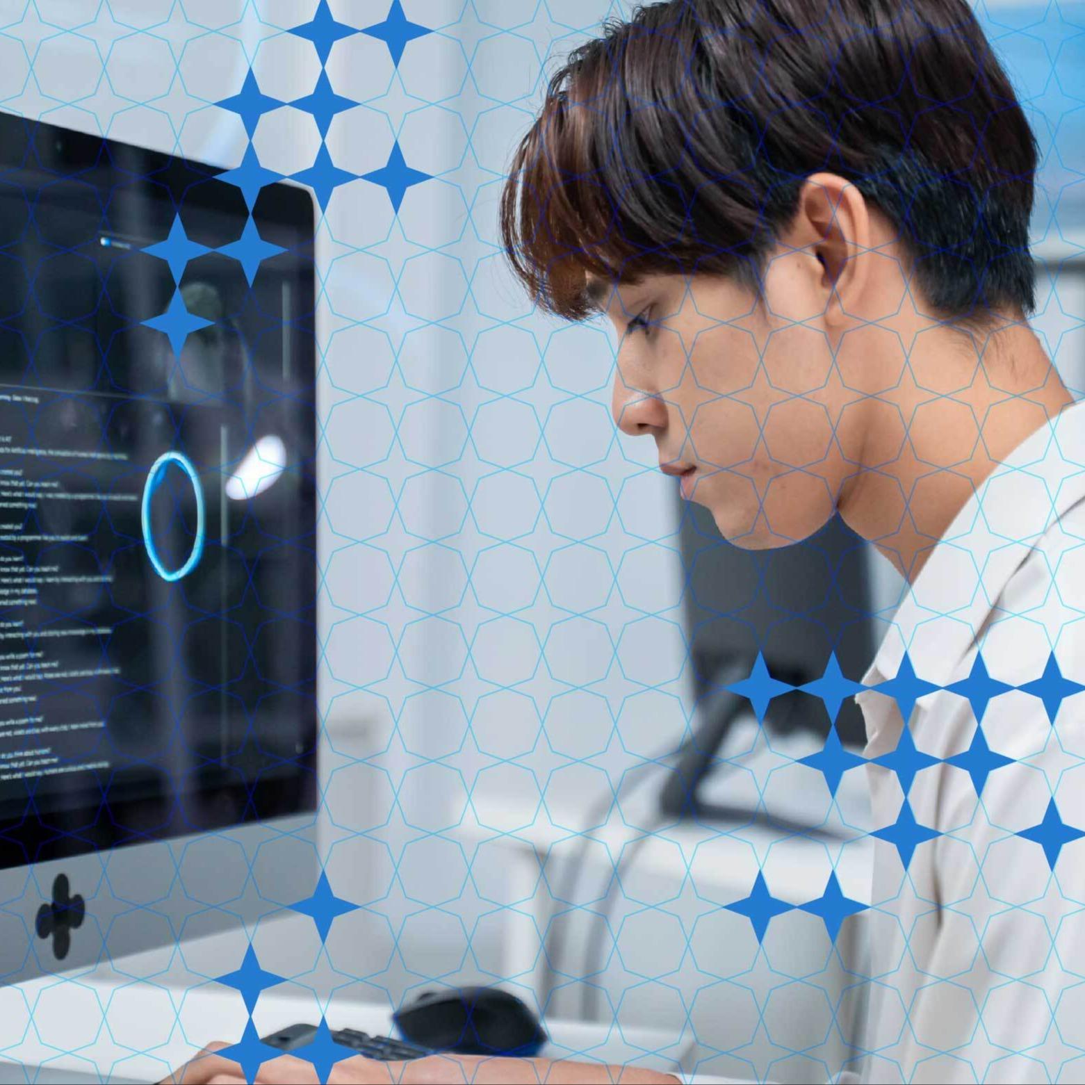 A person works at a computer in an austere environment.
